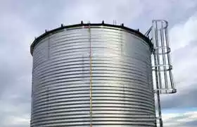 Corrugated steel tank with a roof and a ladder