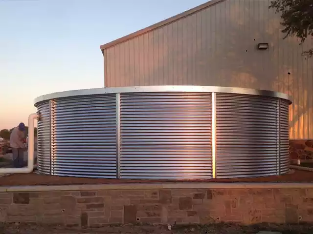 Corrugated tank installed next to a backyard shed