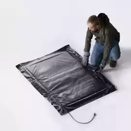 Man laying out a concrete heating blanket