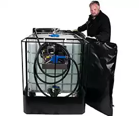Man wrapping heater blanket around IBC tote