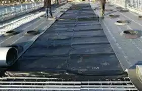 Concrete curing blankets installed on a construction job site