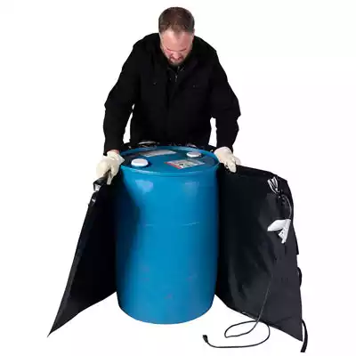 Man wrapping a heating blanket around a 55 gallon drum