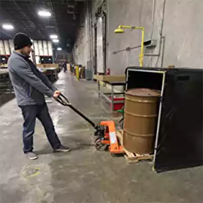 Man putting a drum inside of a Hot Box
