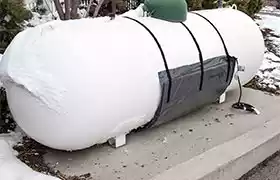 Residential propane tank with a heater blanket installed on the bottom