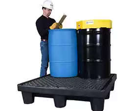 Man reporting on the condition of a drum and barrel on a spill pallet